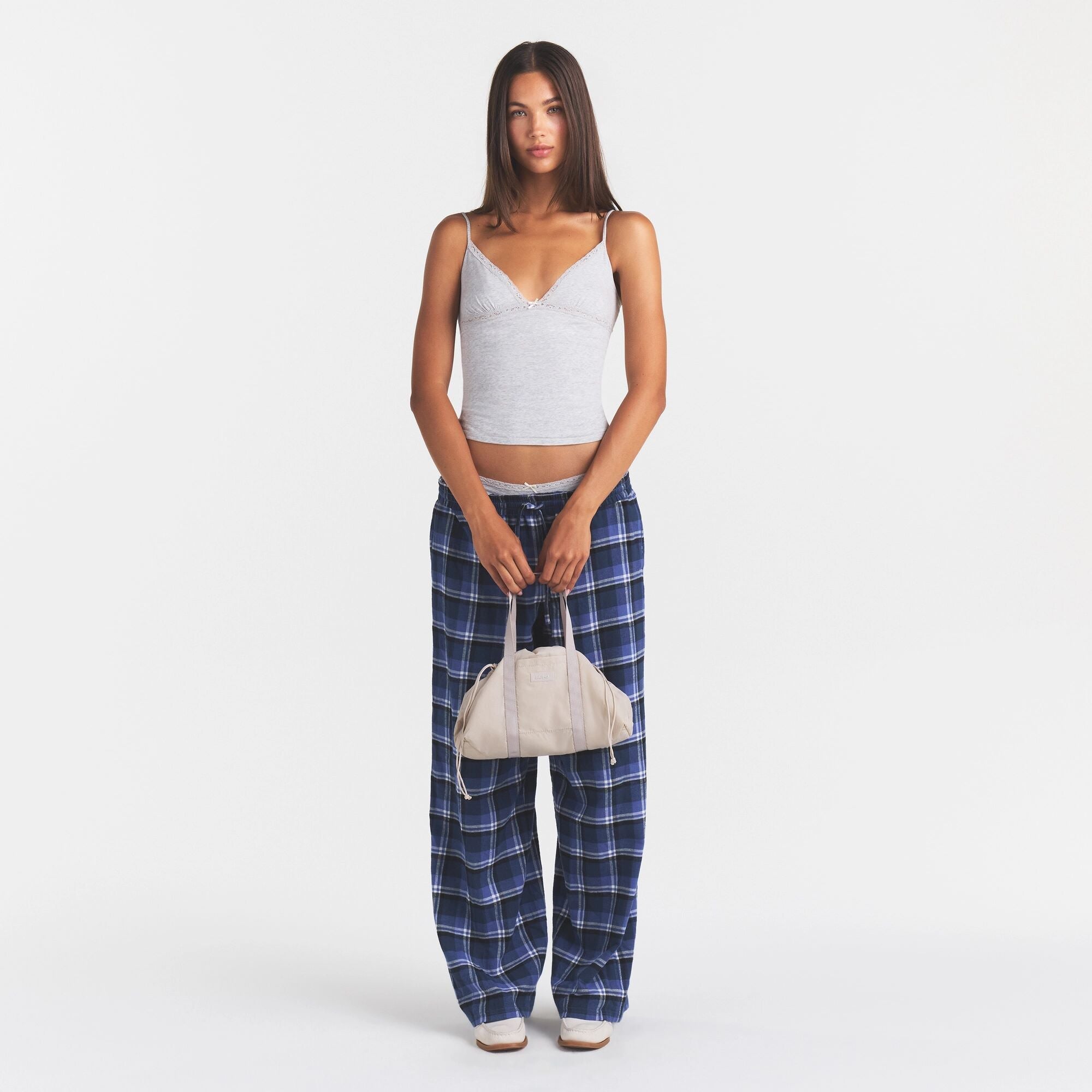 MINI NYLON DRAWSTRING BAG | STONE ON MODEL | FOCUS: 0.0, 1.0, 0.9