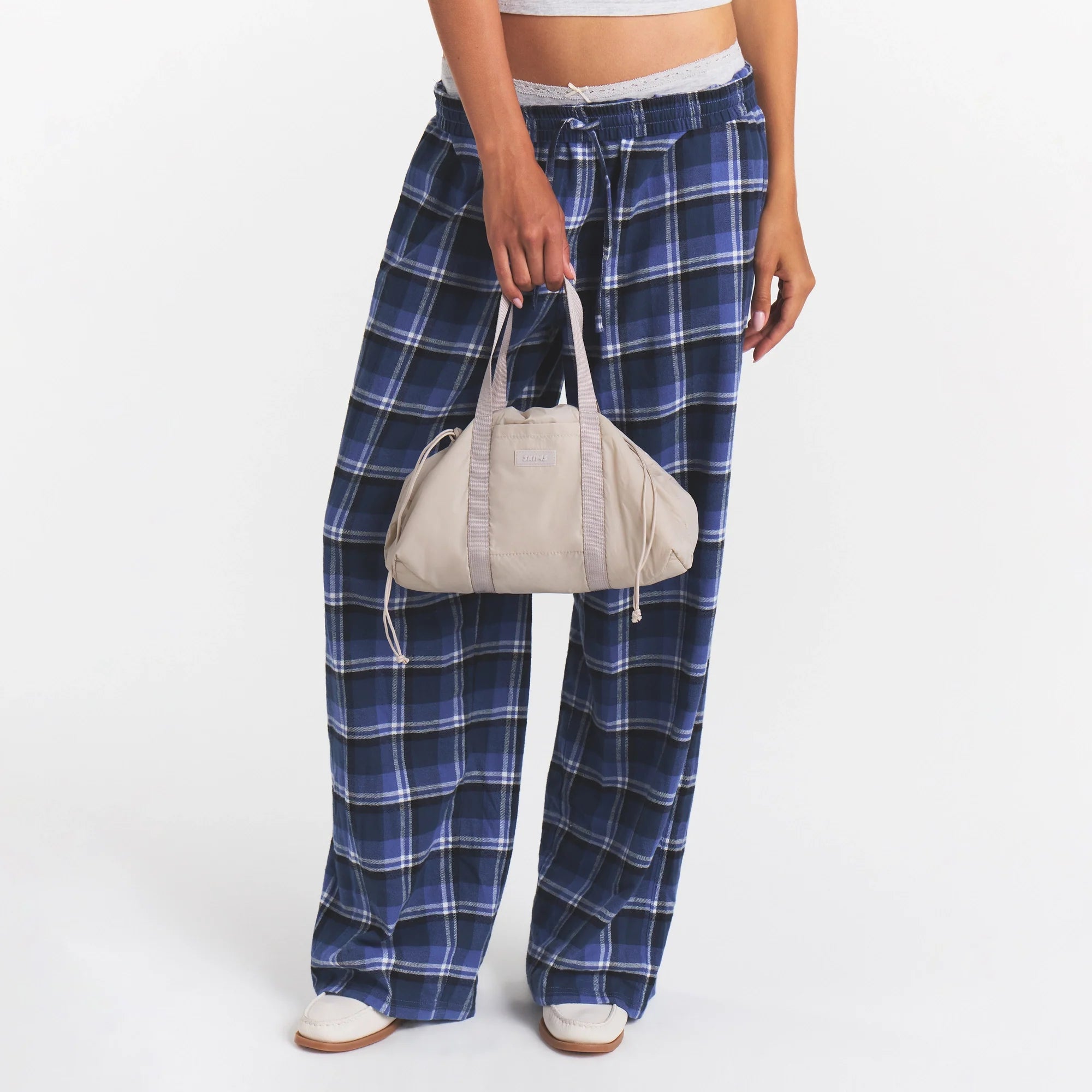 MINI NYLON DRAWSTRING BAG | STONE ON MODEL | FOCUS: 0.0, 1.0, 0.9