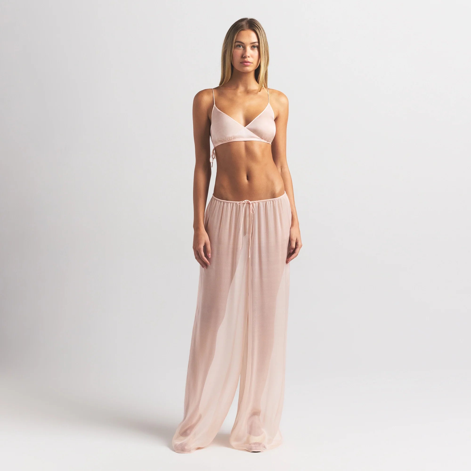 SKIMS ROMANCE SKIMPY WRAP BRALETTE | PRIMROSE ON A MODEL FRONT VIEW @ | FOCUS: 0.0, 1.0, 0.9