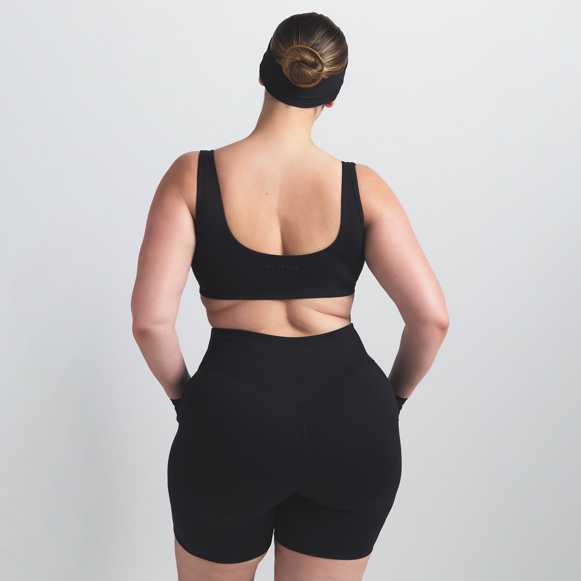 NikeSKIMS MATTE SCOOP NECK BRA | OBSIDIAN ON A MODEL BACK VIEW