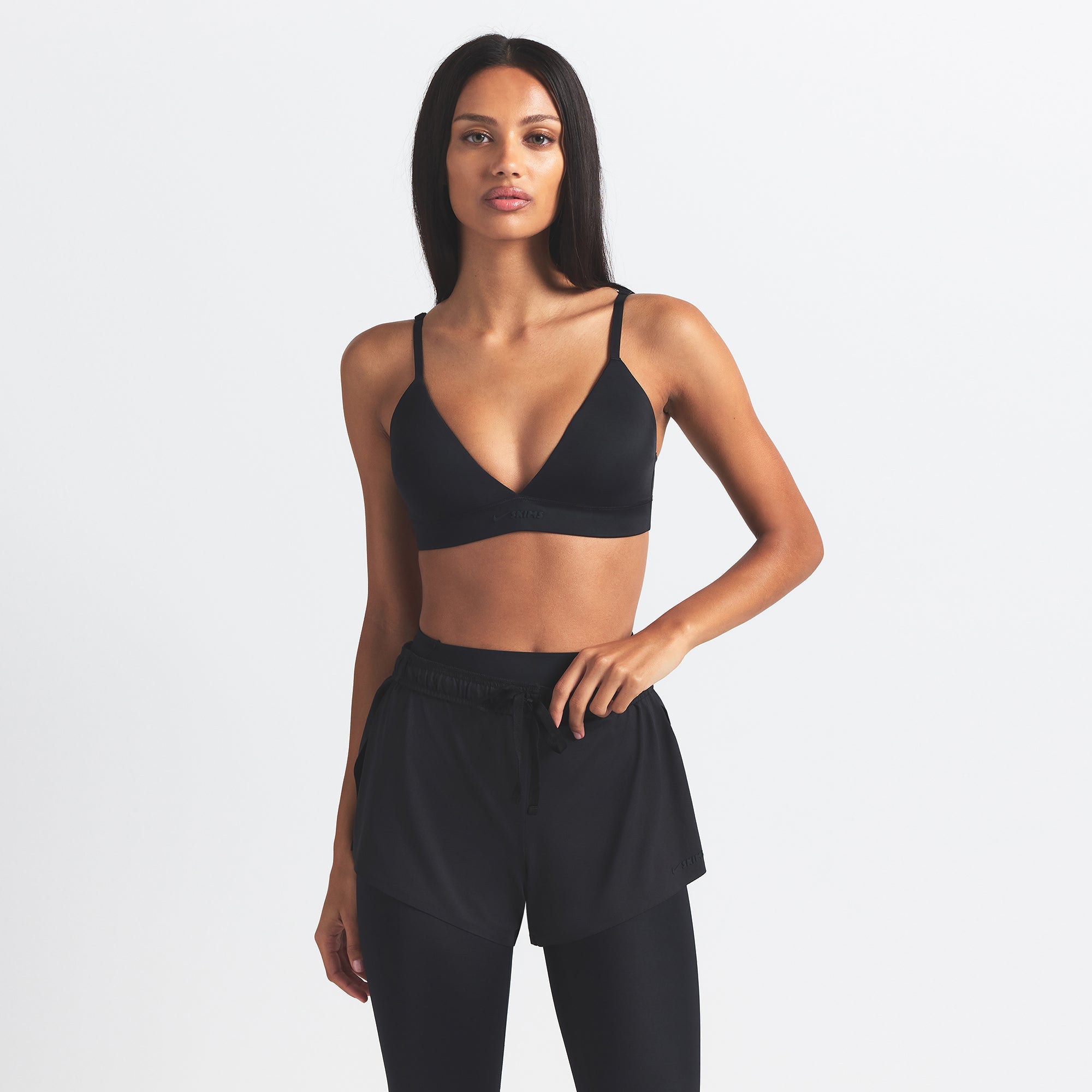 NikeSKIMS SHINE TRIANGLE BRA | OBSIDIAN ON A MODEL SIDE VIEW