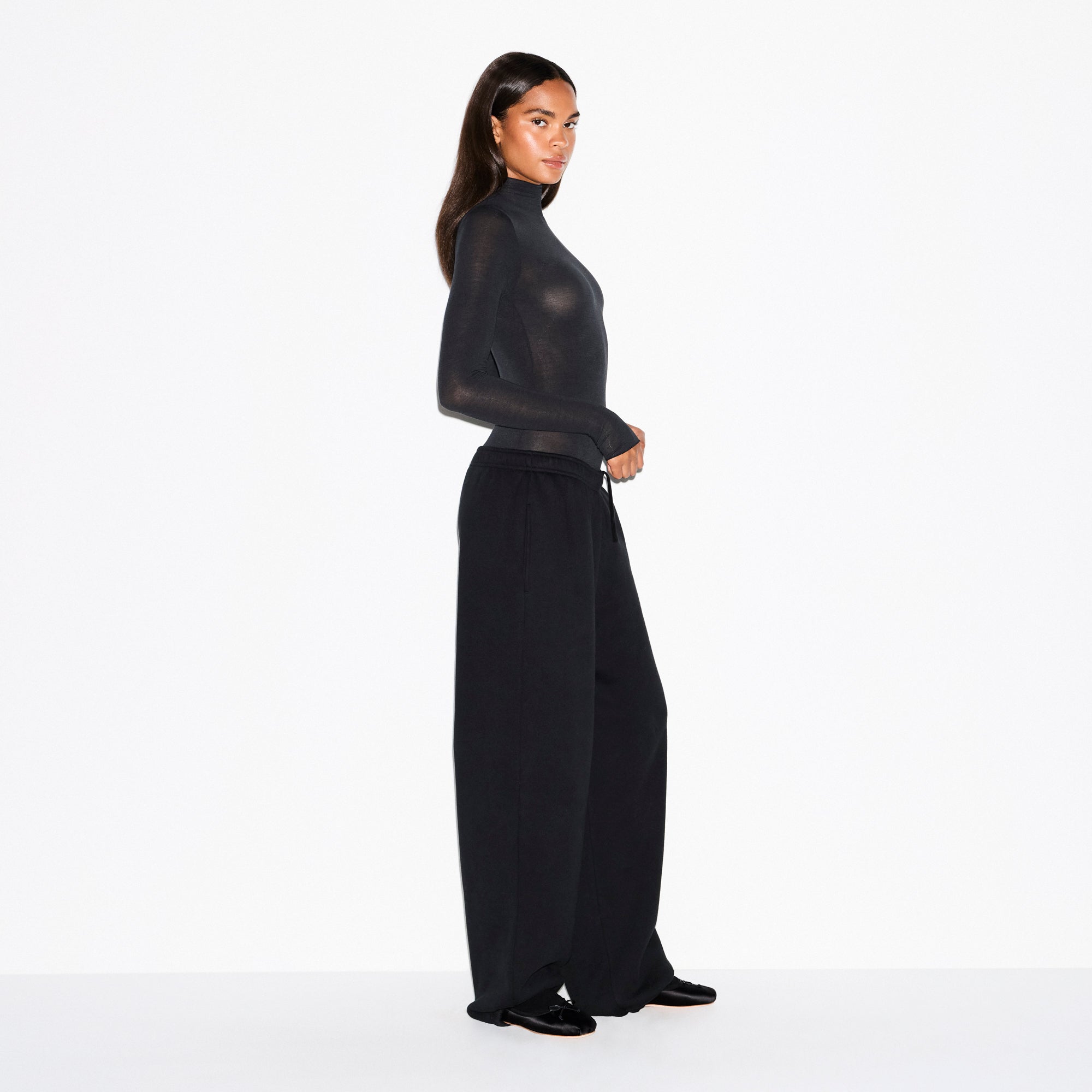 SHEER MODAL LONG SLEEVE TURTLENECK BODYSUIT | ONYX ON A MODEL FRONT VIEW @ | FOCUS: 0.0, 1.0, 0.9