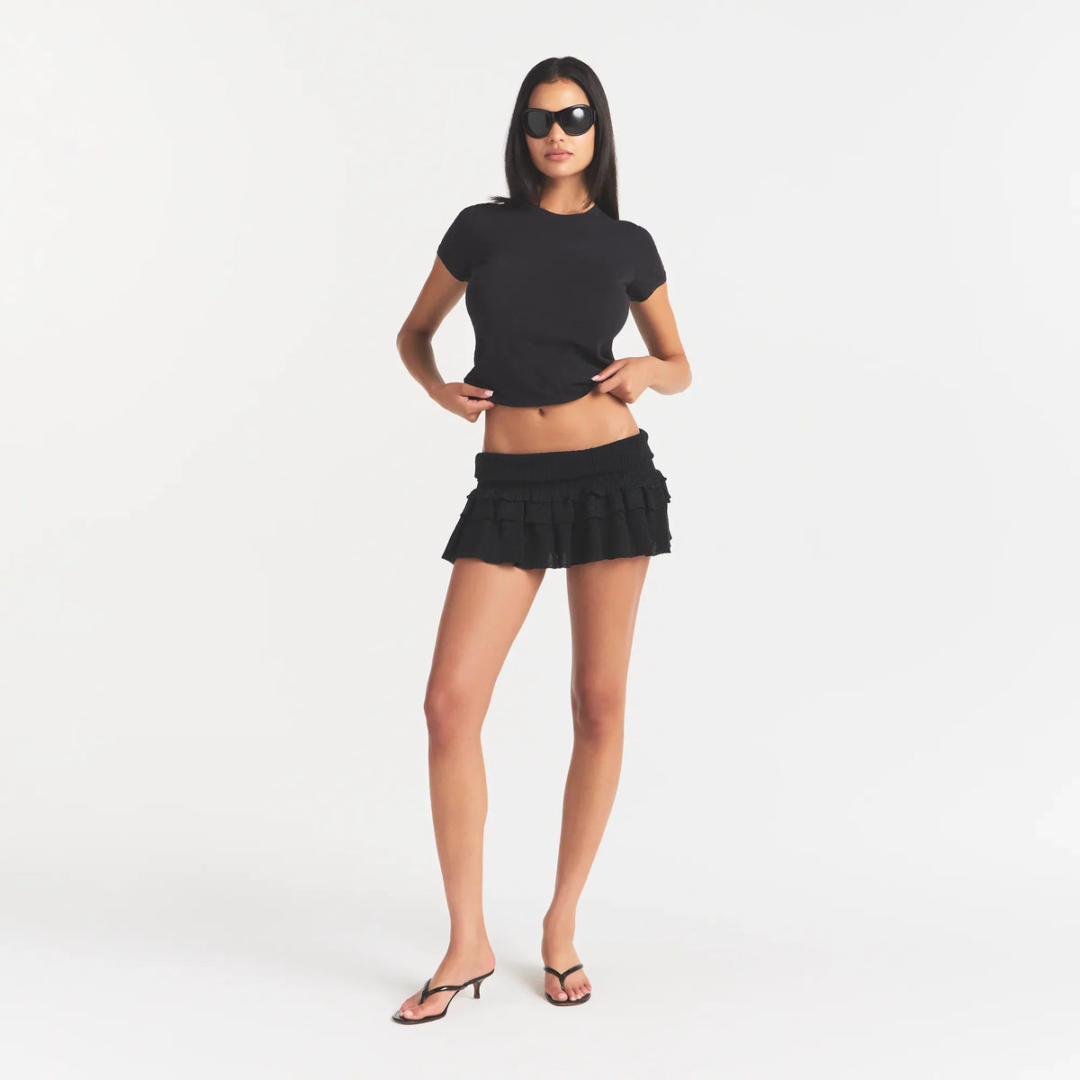 SHEER KNIT RUFFLE MINI SKIRT | ONYX ON A MODEL FRONT VIEW @ | FOCUS: 0.0, 1.0, 0.9