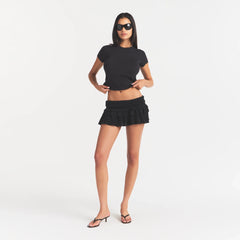 SHEER KNIT RUFFLE MINI SKIRT | ONYX ON A MODEL FRONT VIEW @ | FOCUS: 0.0, 1.0, 0.9