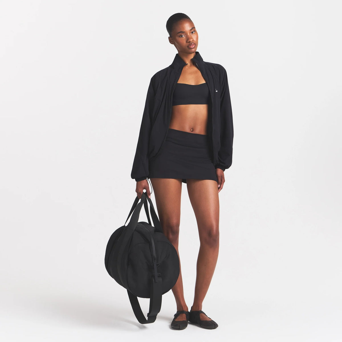 NikeSKIMS MATTE SKORT | NSKM OBSIDIAN ON A MODEL
