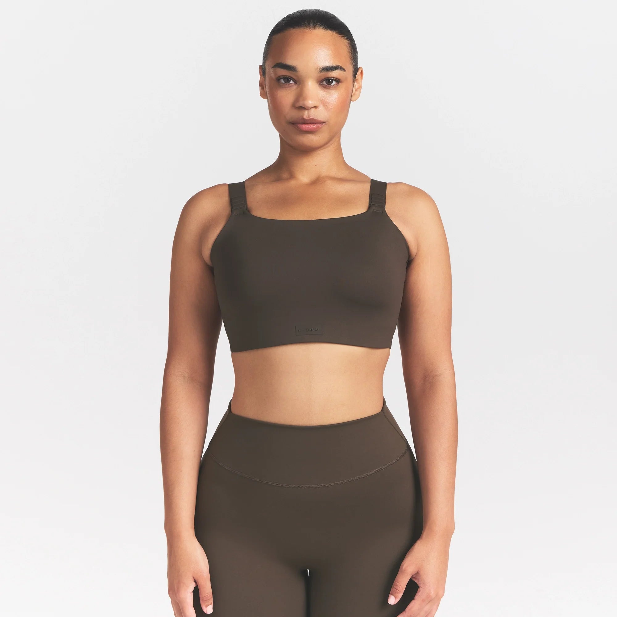 NikeSKIMS MATTE WIDE STRAP BRA | DARK SEPIA ON A MODEL FRONT VIEW @ | FOCUS: 0.9, 0.1, 0.7