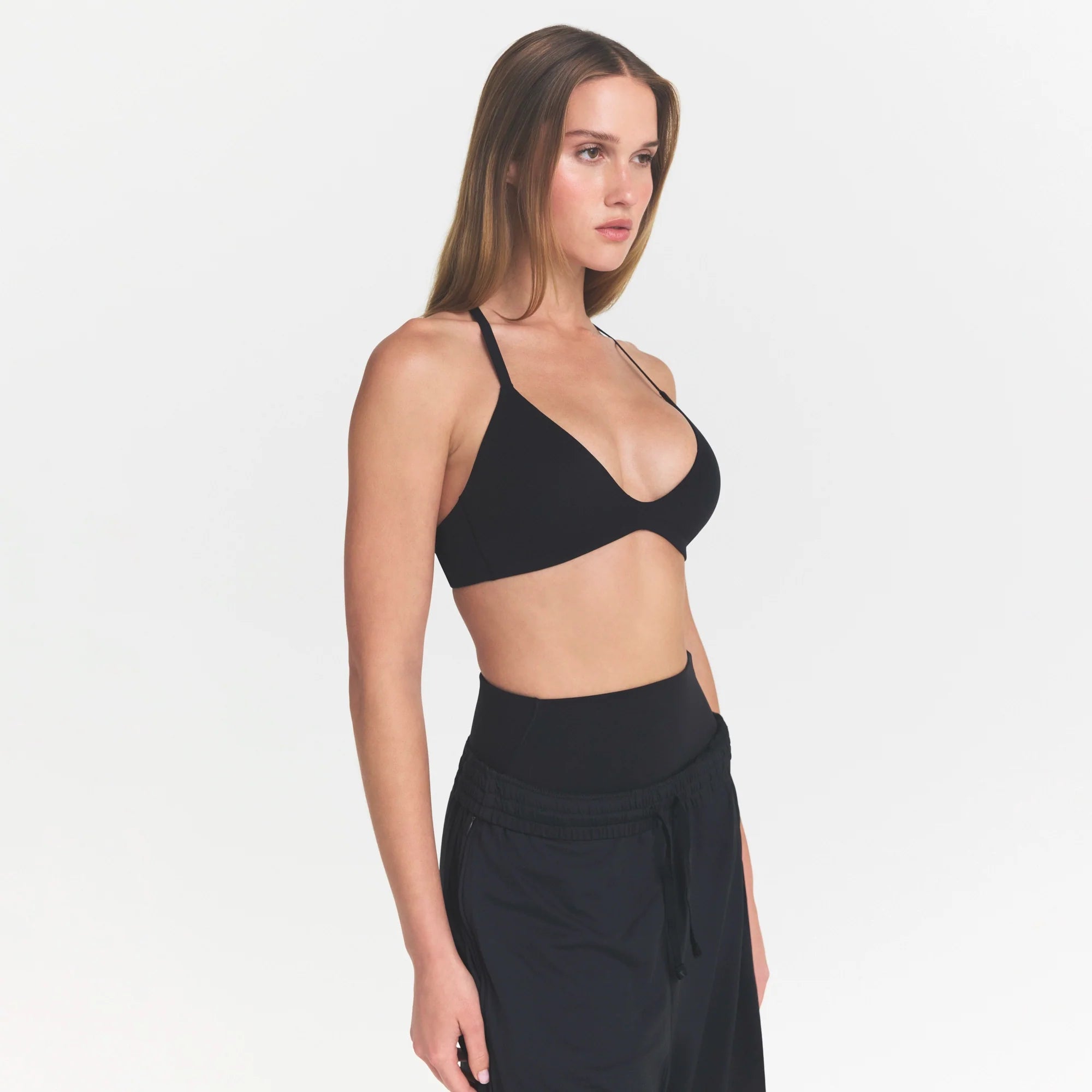 NikeSKIMS STUDIO STRETCH T-BACK TRIANGLE BRA | OBSIDIANON A MODEL FRONT