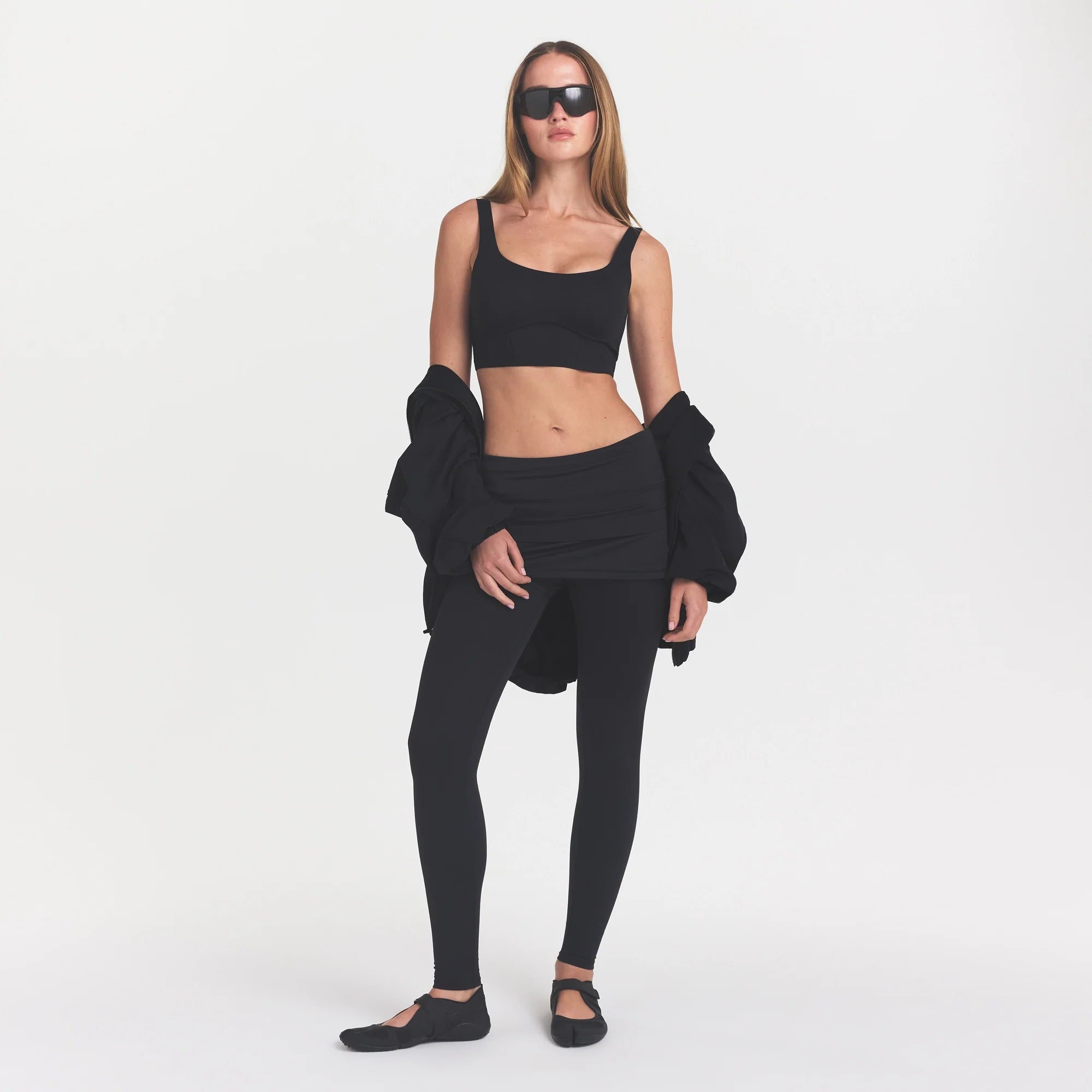 NikeSKIMS MATTE CORSET LONGLINE BRA | OBSIDIAN ON A MODEL
