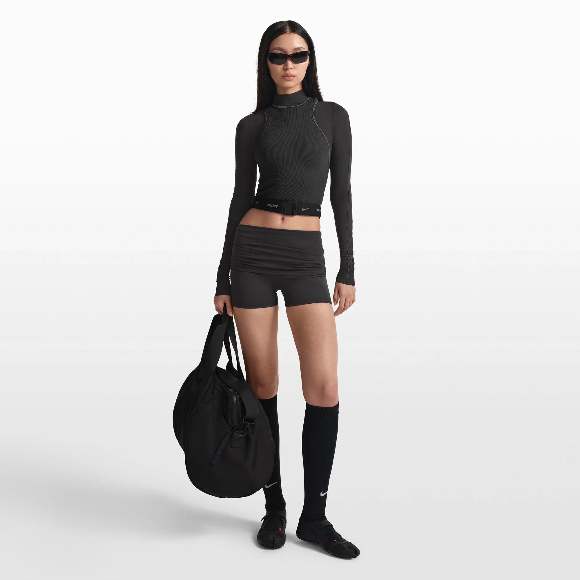 NikeSKIMS ACCESSORIES WAISTPACK | OBSIDIAN ON A MODEL FRONT VIEW @ | FOCUS: 0.0, 1.0, 0.9