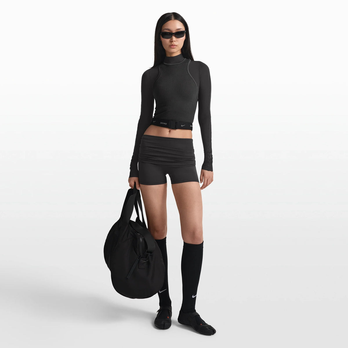 NikeSKIMS ACCESSORIES WAISTPACK | OBSIDIAN ON A MODEL FRONT VIEW @ | FOCUS: 0.0, 1.0, 0.9
