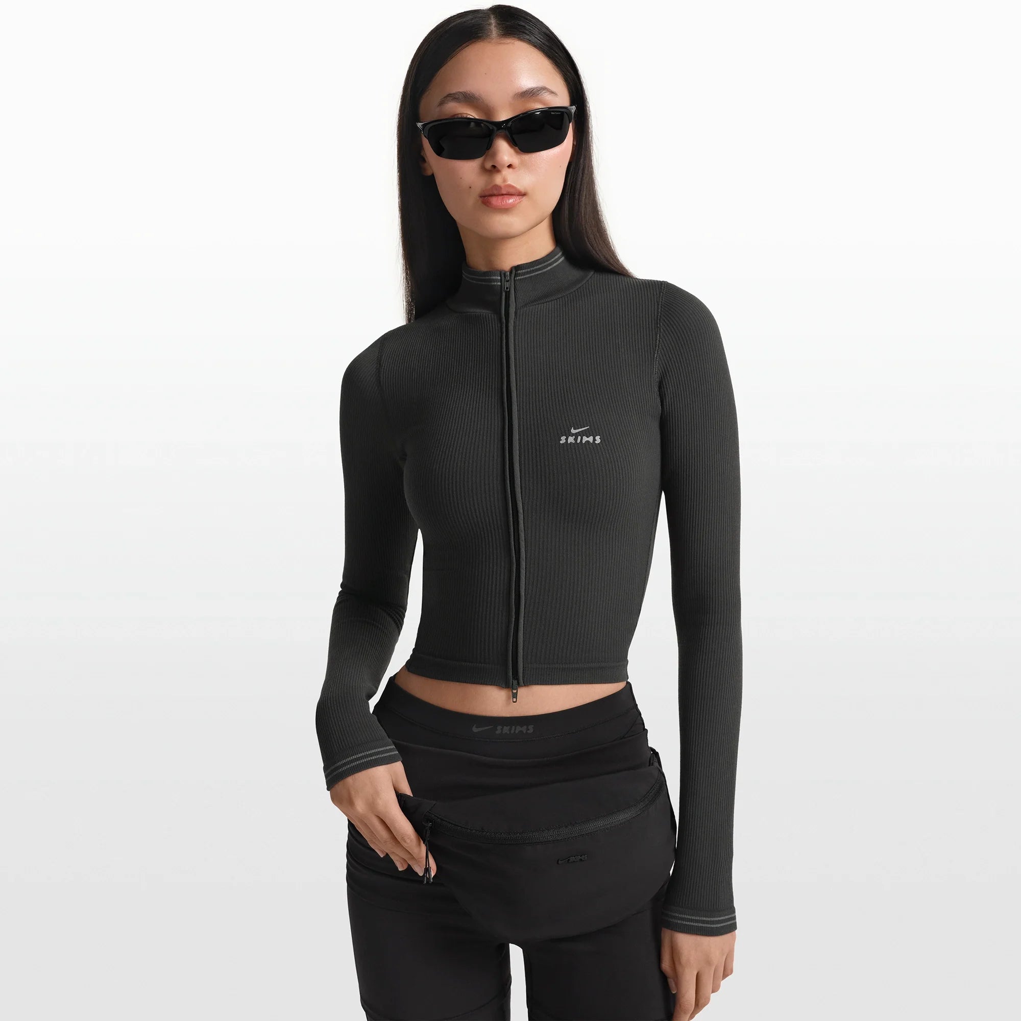 NikeSKIMS ACCESSORIES FANNY PACK | OBSIDIAN ON A MODEL FRONT VIEW @ | FOCUS: 0.0, 1.0, 0.9