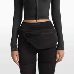 NikeSKIMS ACCESSORIES FANNY PACK | OBSIDIAN ON A MODEL FRONT VIEW @ | FOCUS: 0.0, 1.0, 0.9