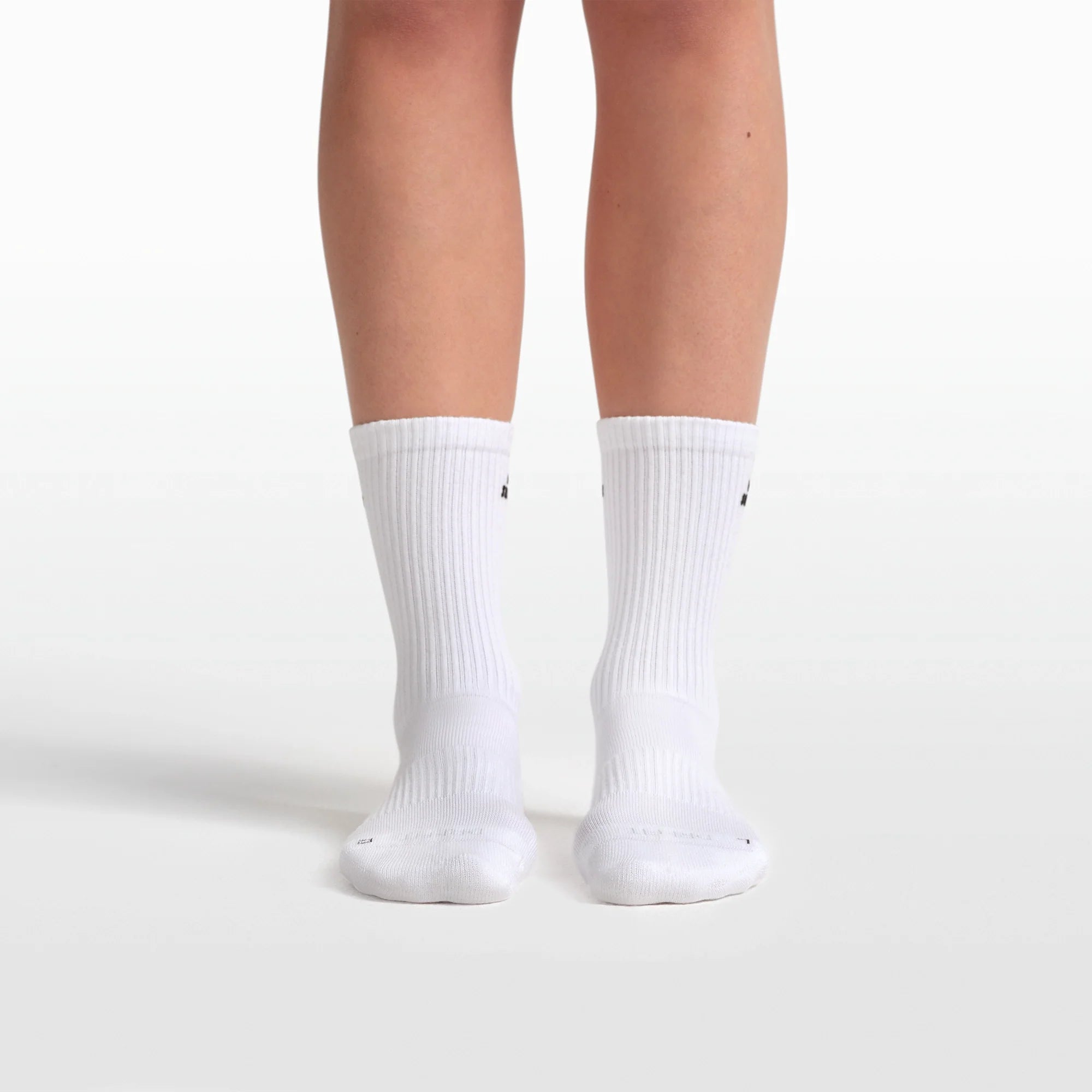 NikeSKIMS ACCESSORIES DRI-FIT PILATES GRIP CREW SOCK | SNOW FLAT ON A WHITE BACKGROUND