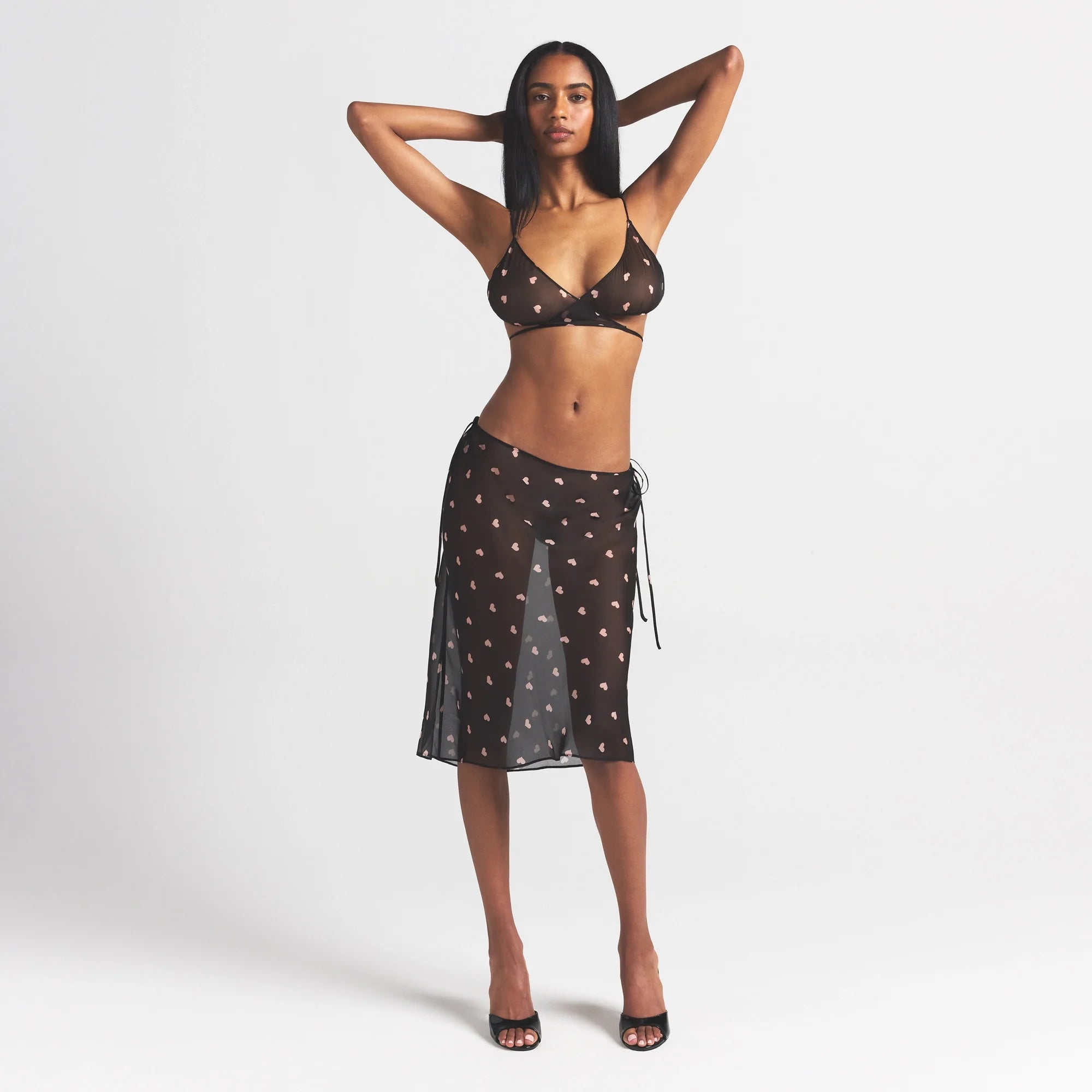 SKIMS ROMANCE MIDI SKIRT | OBSIDIAN SPACED HEARTS ON A MODEL FRONT VIEW @ | FOCUS: 0.0, 1.0, 0.9