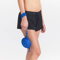 NikeSKIMS ACCESSORIES HARDSHELL ROUND CASE | COBALT ON A MODEL SIDE VIEW @ | FOCUS: 0.0, 1.0, 0.9