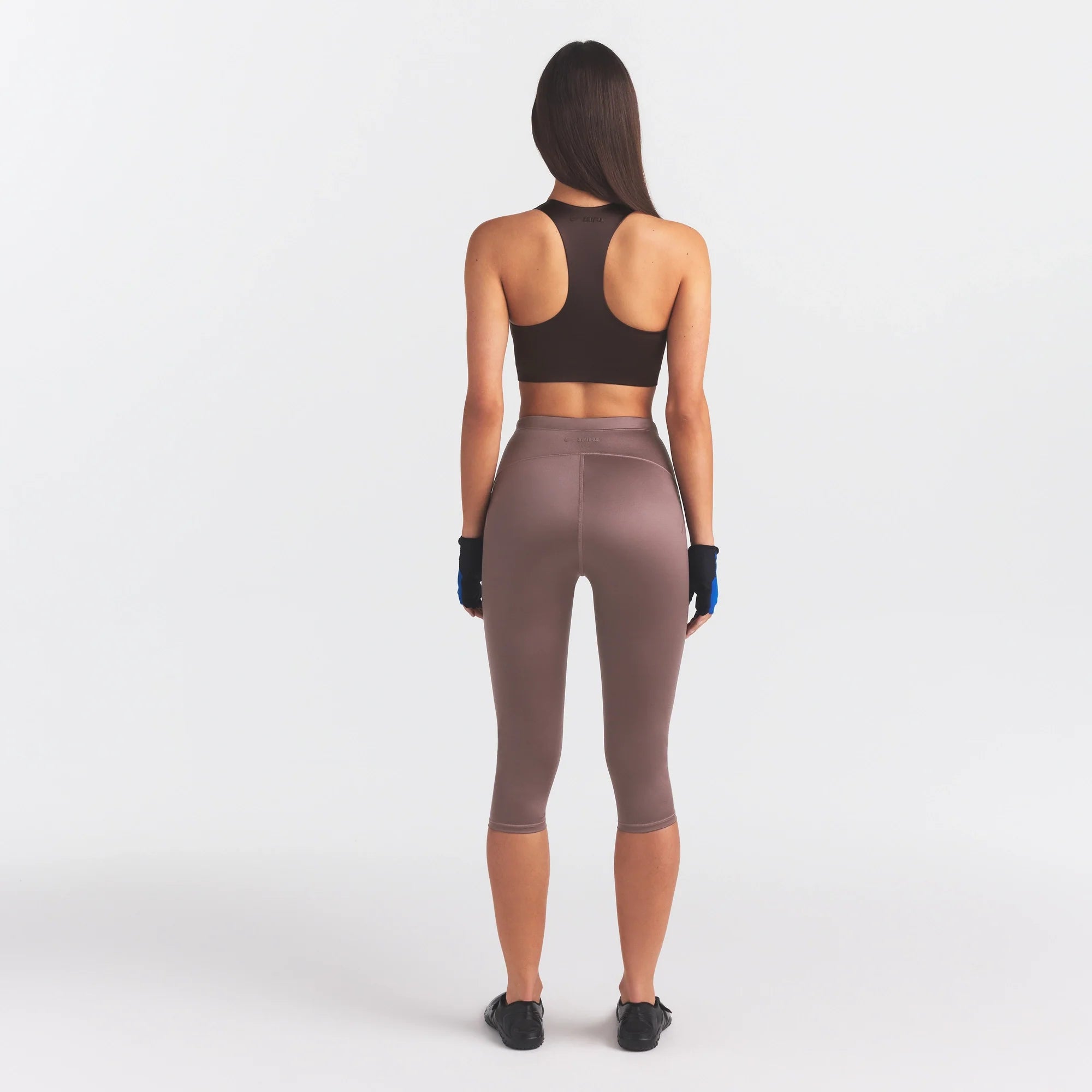 NikeSKIMS SATIN SHINE CAPRI 17" LEGGING | RESIN ON A MODEL FRONT VIEW