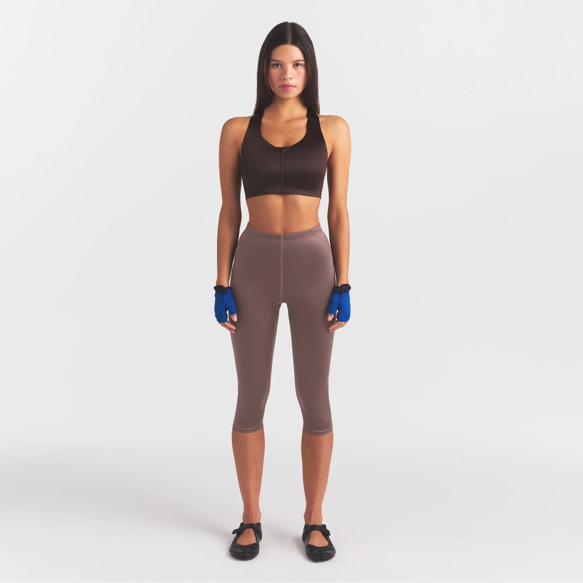 NikeSKIMS SATIN SHINE CAPRI 17" LEGGING | RESIN ON A MODEL FRONT VIEW