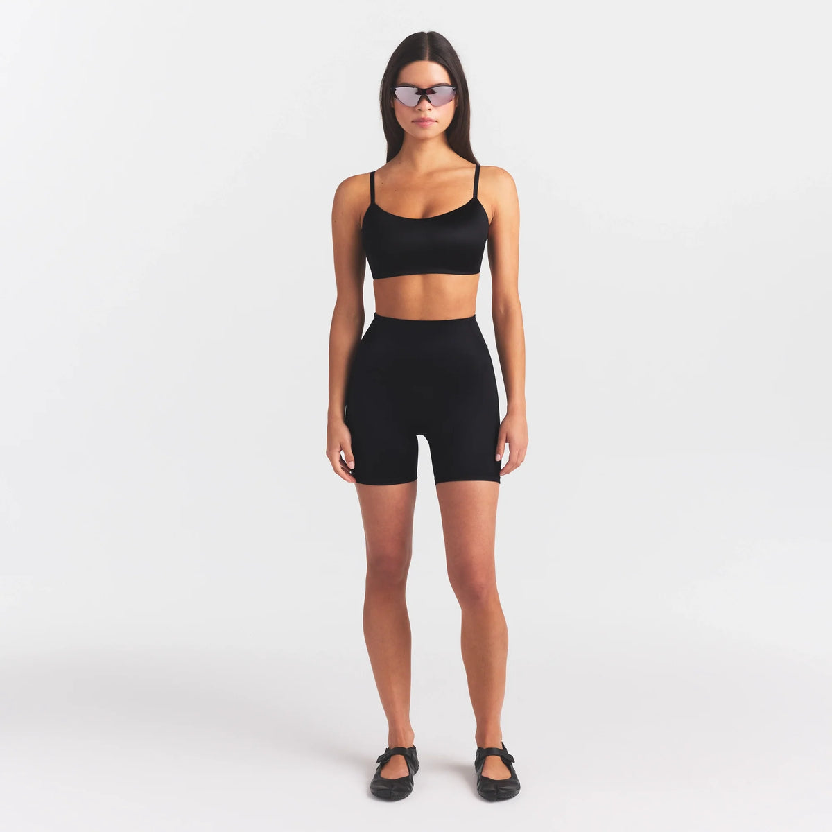 NikeSKIMS SATIN SHINE BONDED WAIST 5" BIKER SHORT | OBSIDIAN ON A MODEL FRONT VIEW