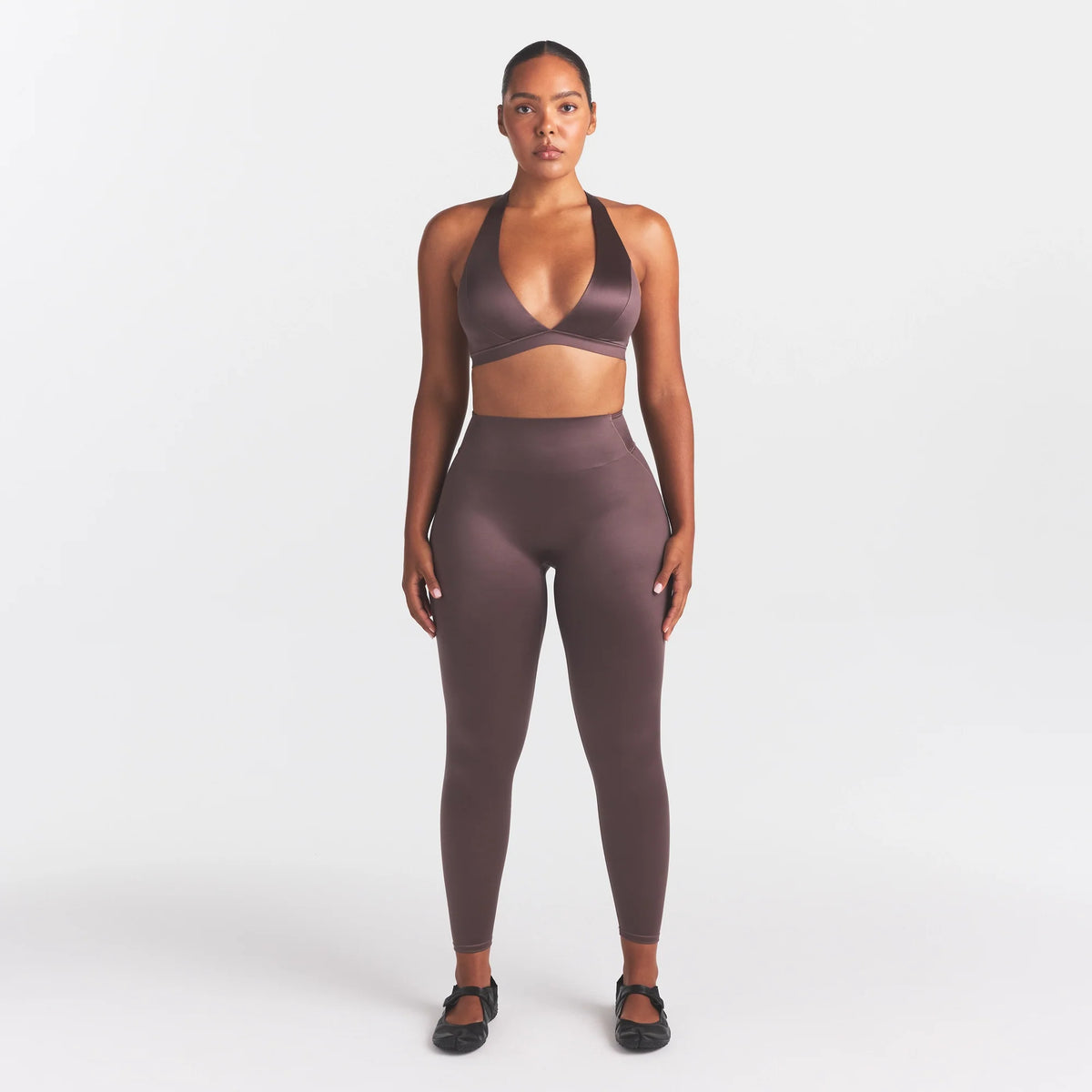 NikeSKIMS SATIN SHINE BONDED WAIST 26" LEGGING | RESIN ON A MODEL FRONT VIEW