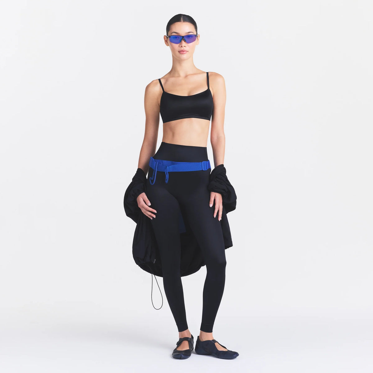 NikeSKIMS SATIN SHINE BONDED WAIST 29" LEGGING | OBSIDIAN ON A MODEL FRONT VIEW