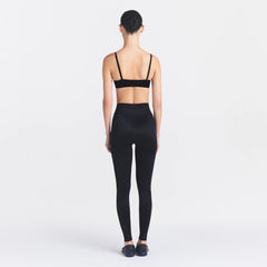 NikeSKIMS SATIN SHINE BONDED WAIST 29" LEGGING | OBSIDIAN ON A MODEL FRONT VIEW