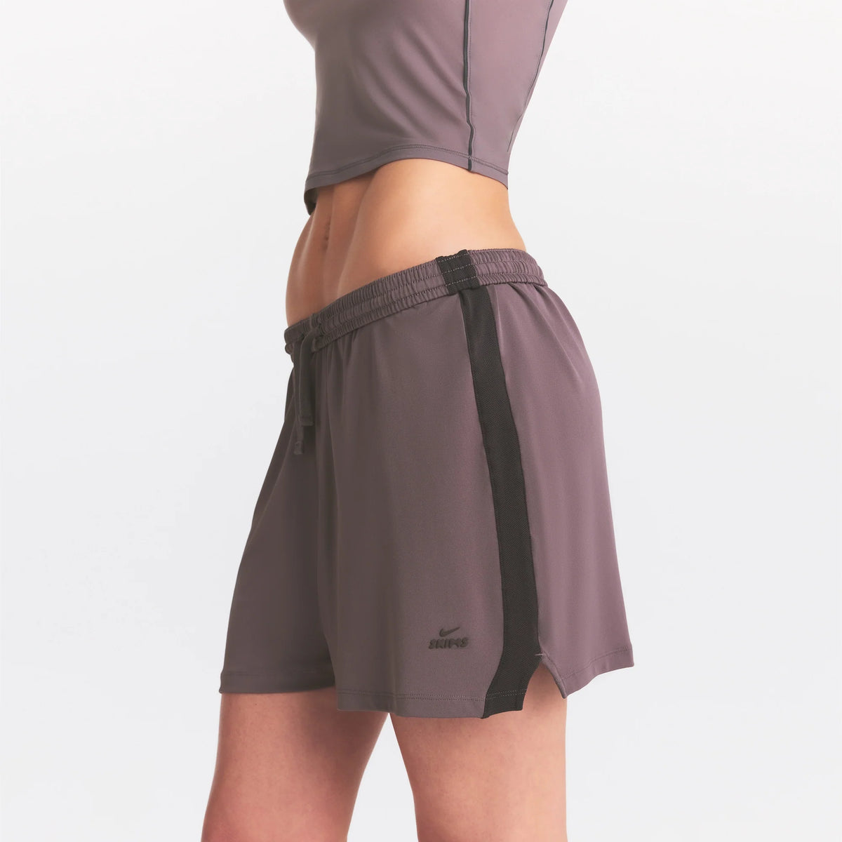NikeSKIMS STRETCH KNIT DOLPHIN SHORT | RESIN ON A MODEL SIDE VIEW @ | FOCUS: 0.0, 1.0, 0.9