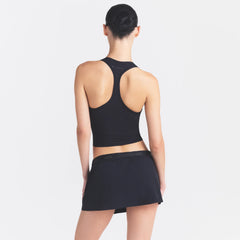 NikeSKIMS STRETCH NYLON SKORT | OBSIDIAN ON A MODEL SIDE VIEW @ | FOCUS: 0.0, 1.0, 0.9