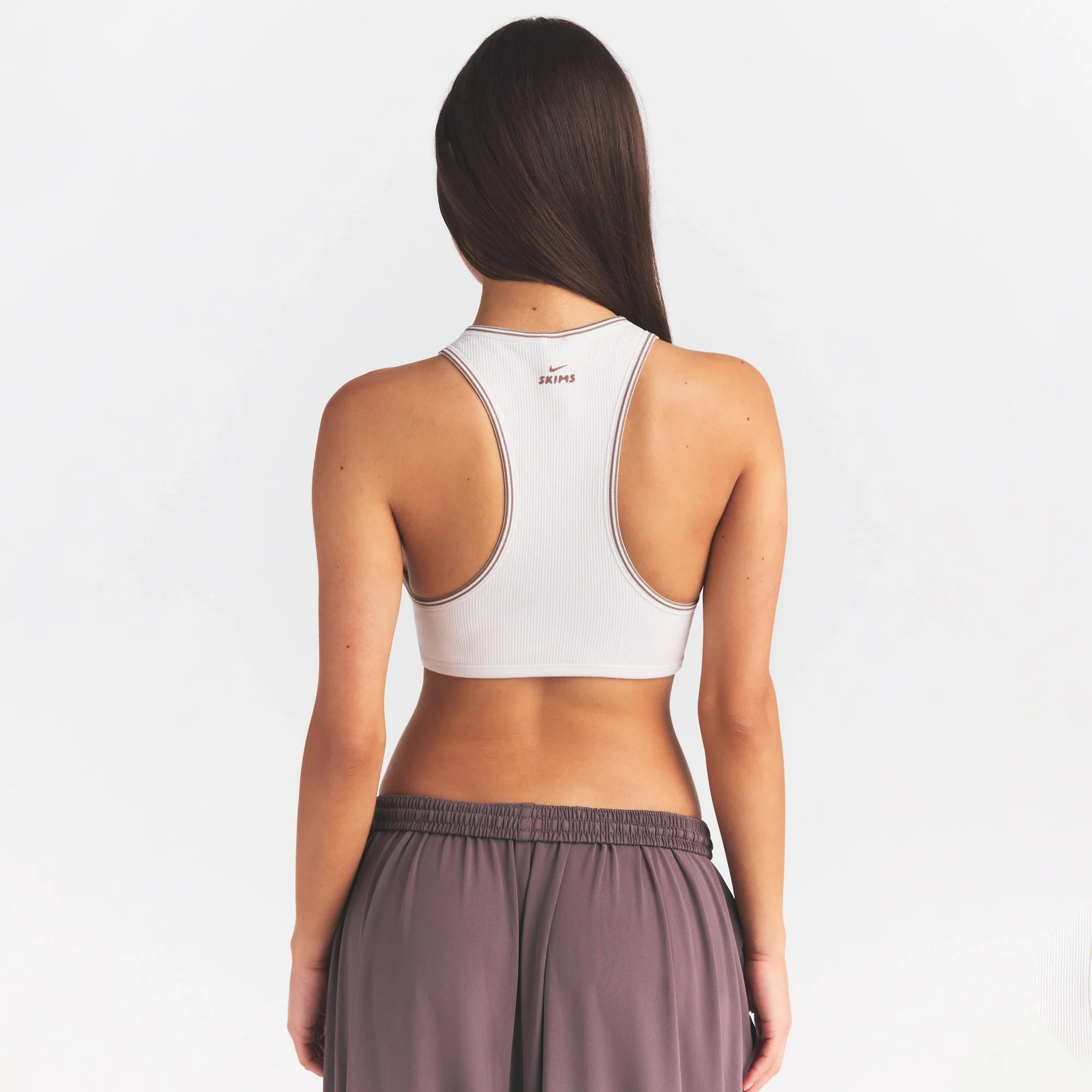 NikeSKIMS RIBBED SEAMLESS RACER FRONT BRA | IVORY ON A MODEL SIDE VIEW @ | FOCUS: 0.0, 1.0, 0.9