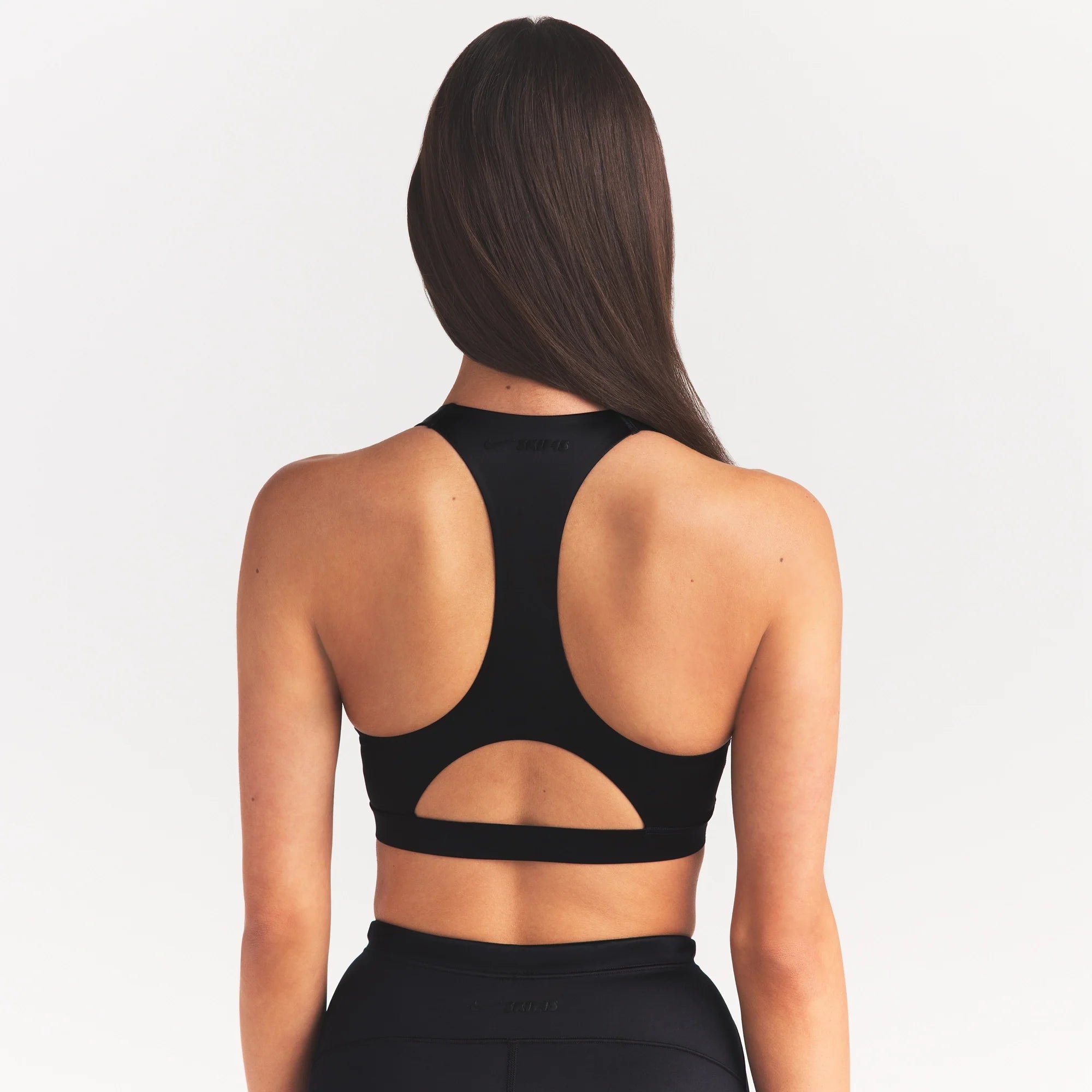 NikeSKIMS SATIN SHINE RACERBACK BRA BRA | OBSIDIAN ON A MODEL SIDE VIEW @ | FOCUS: 0.0, 1.0, 0.9