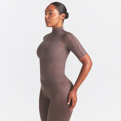 NikeSKIMS WEIGHTLESS LAYERS MOCK NECK SHORT SLEEVE T-SHIRT | RESIN ON A MODEL SIDE VIEW @ | FOCUS: 0.0, 1.0, 0.9