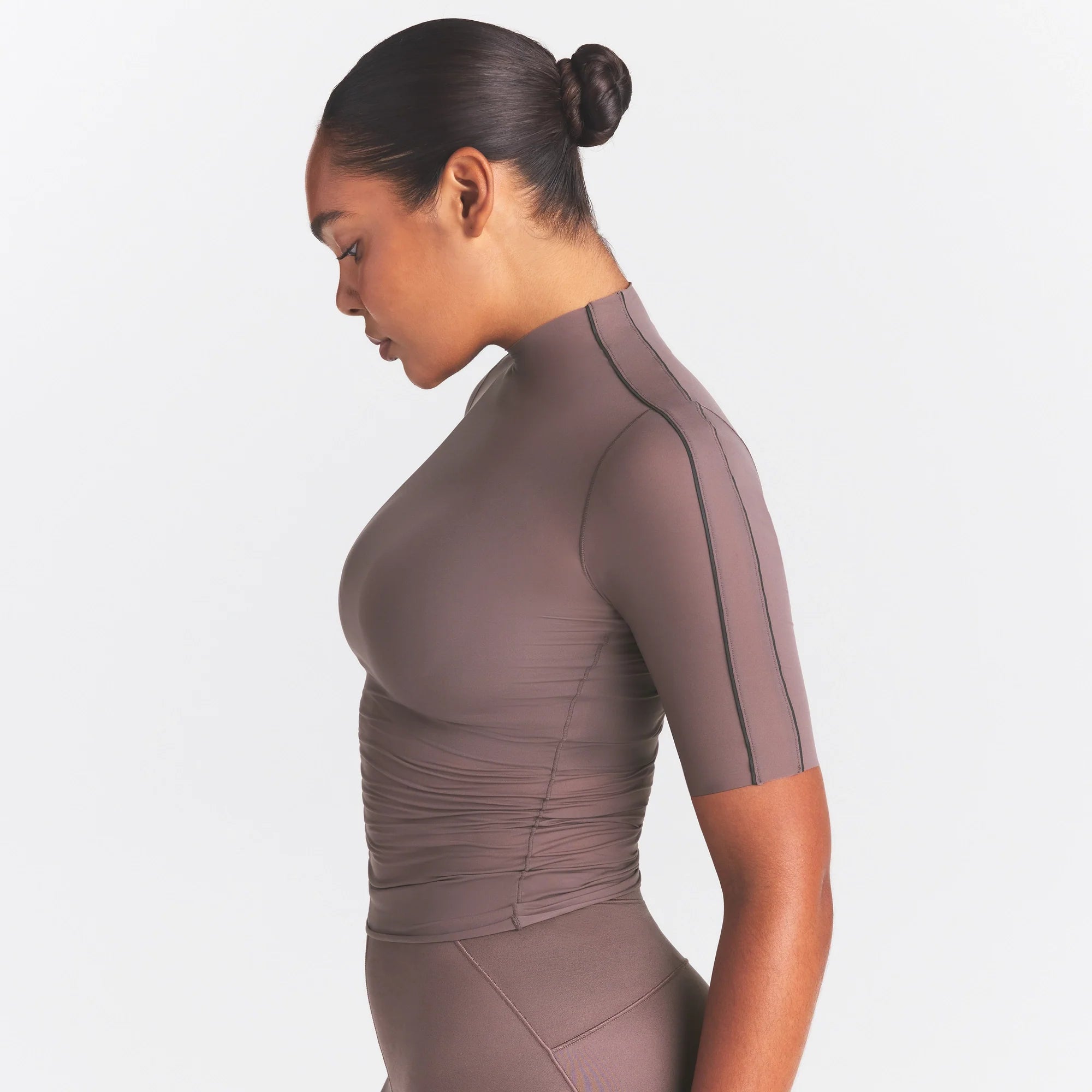NikeSKIMS WEIGHTLESS LAYERS MOCK NECK SHORT SLEEVE T-SHIRT | RESIN ON A MODEL SIDE VIEW @ | FOCUS: 0.0, 1.0, 0.9