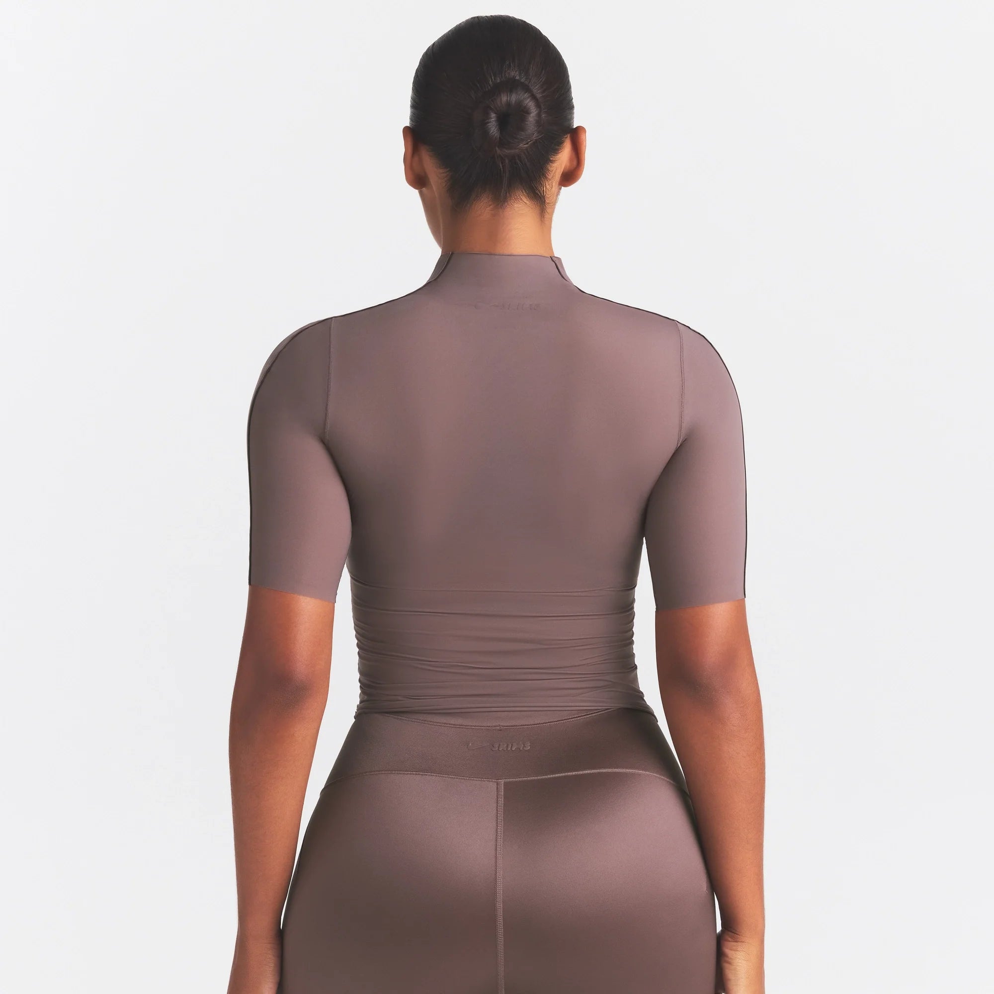 NikeSKIMS WEIGHTLESS LAYERS MOCK NECK SHORT SLEEVE T-SHIRT | RESIN ON A MODEL SIDE VIEW @ | FOCUS: 0.0, 1.0, 0.9