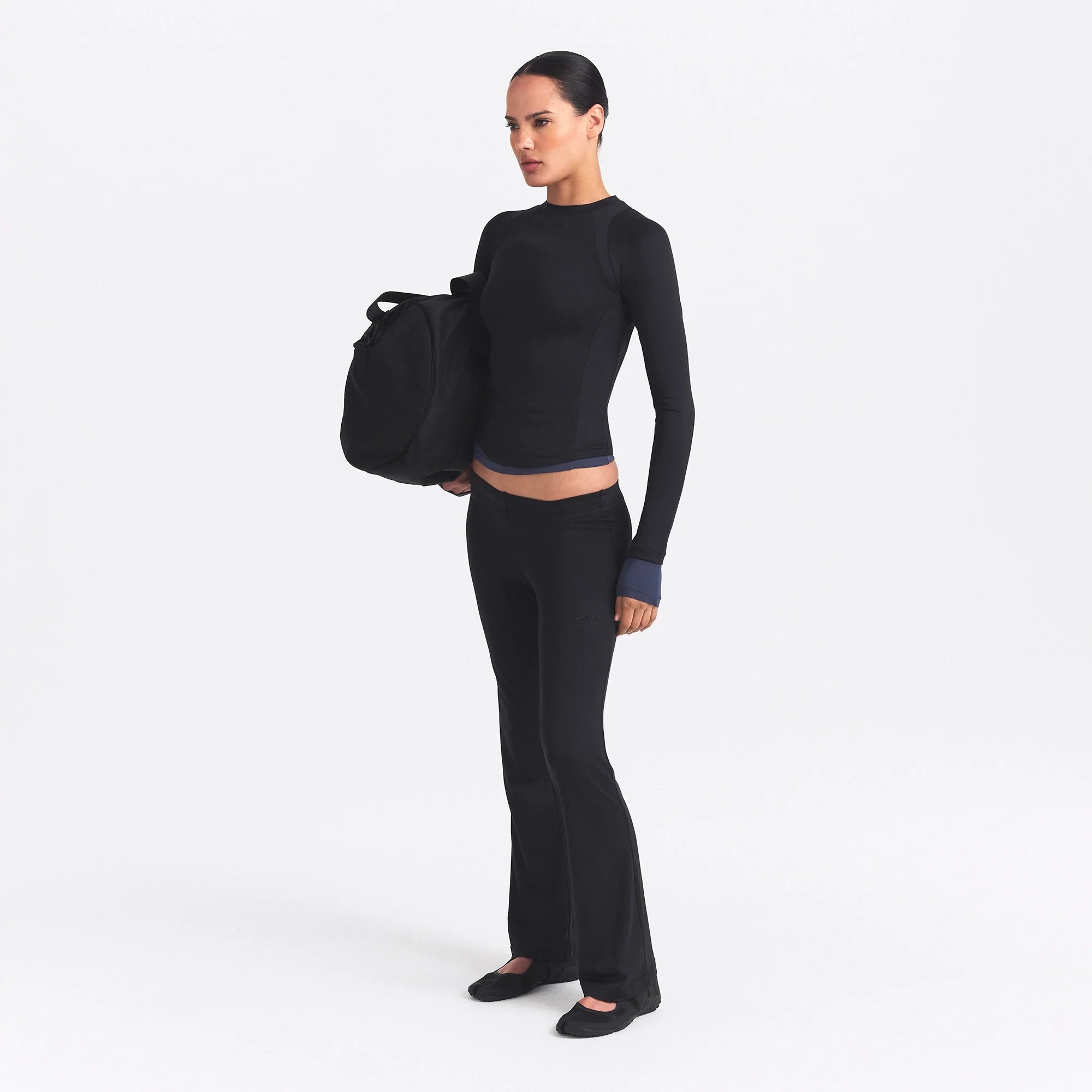 NikeSKIMS AIRY STRAIGHT LEG PANT | OBSIDIAN ON A MODEL SIDE VIEW @ | FOCUS: 0.0, 1.0, 0.9