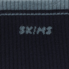 RIBBED QUARTER CREW LOGO SOCK | NAVY AND KYANITE & LAYS FLAT ON A WHITE BACKGROUND | FLT