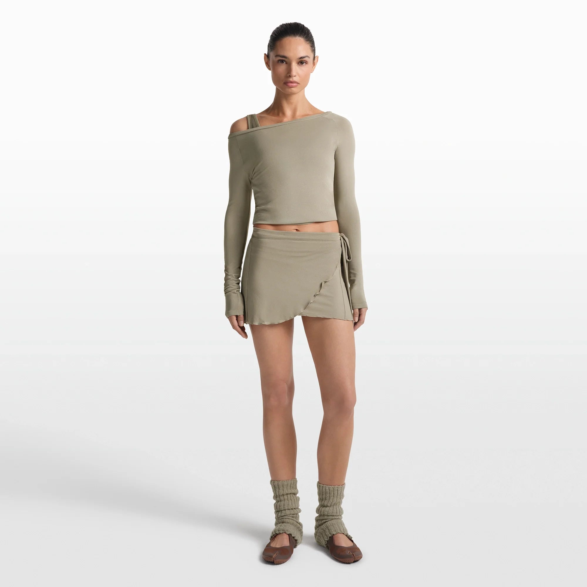 NikeSKIMS STRETCH KNIT WRAP SKIRT | DUNE ON A MODEL FRONT VIEW @ | FOCUS: 0.0, 1.0, 0.9