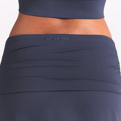 NikeSKIMS AIRY FOLDOVER SKORT | DEEP ROYAL ON A MODEL SIDE VIEW @ | FOCUS: 0.0, 1.0, 0.9
