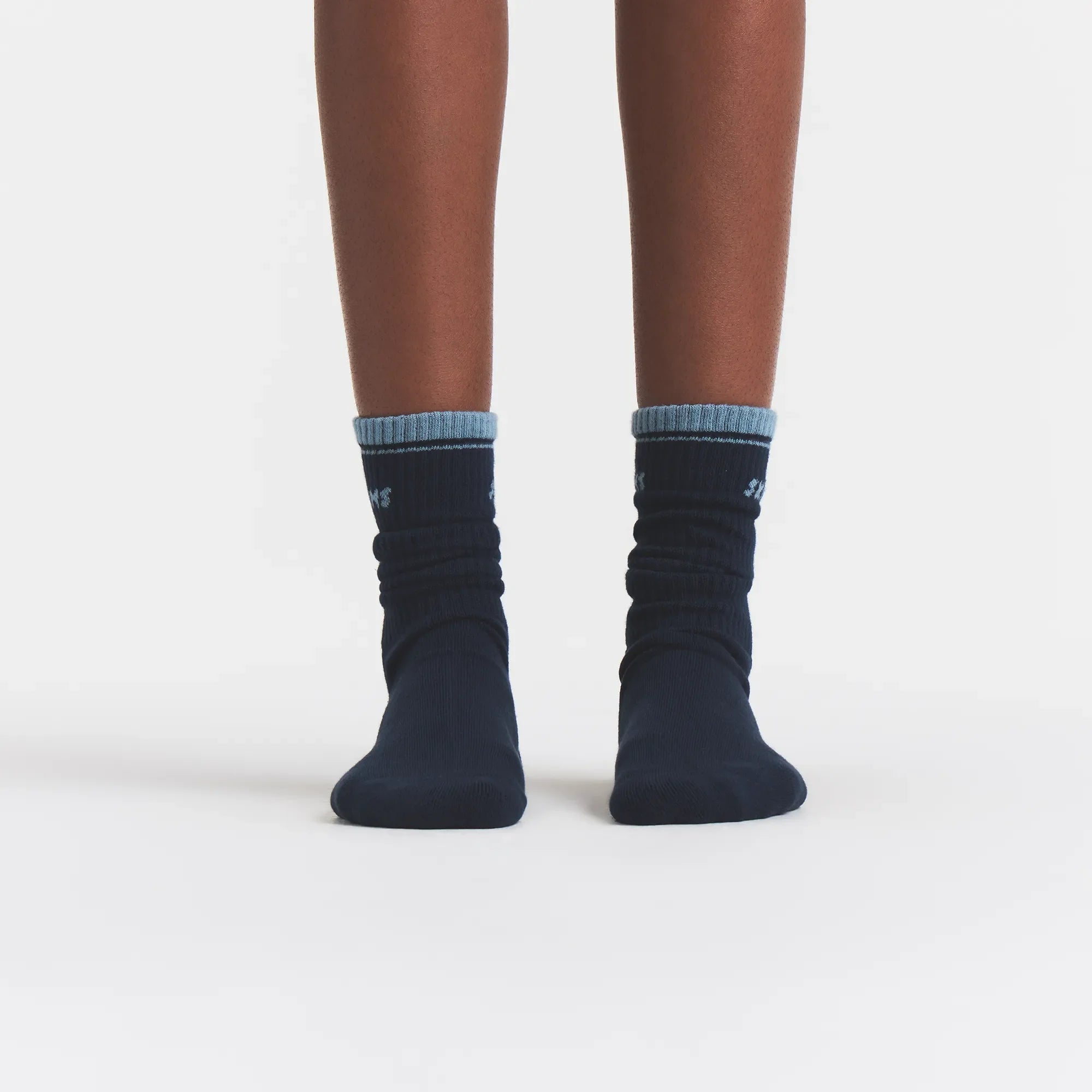 RIBBED CREW LOGO SOCK | NAVY AND KYANITE ON A MODEL | FOCUS: 0.0, 1.0, 0.9
