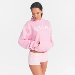 COTTON FLEECE CLASSIC HOODIE | HALITE WITH SNOW LOGO ON A MODEL SIDE VIEW @ | FOCUS: 0.0, 1.0, 0.9